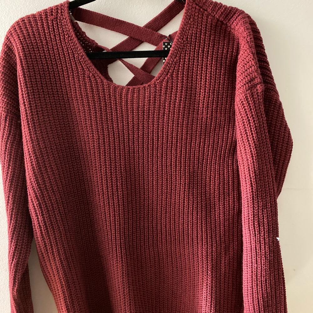 Sweater with crisscrossed work on the back